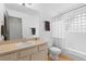 Bright bathroom with a single sink vanity and a shower/tub combo at 3695 Quail St, Wheat Ridge, CO 80033