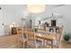 Light-filled dining area with hardwood floors providing seamless transition to the adjacent kitchen at 3695 Quail St, Wheat Ridge, CO 80033