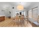 Bright dining room with hardwood floors offering views to kitchen and front door at 3695 Quail St, Wheat Ridge, CO 80033