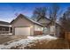 Charming single-Gathering home boasts a two-car garage and a pop of color with the bright teal front door at 3695 Quail St, Wheat Ridge, CO 80033