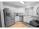 Modern kitchen featuring stainless steel appliances, granite countertops, and ample cabinet space for storage at 3695 Quail St, Wheat Ridge, CO 80033