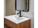 Close up of bathroom sink and mirror with modern vanity and lighting at 2500 S York St # 204, Denver, CO 80210