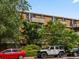 Brick apartment building with balconies, lush landscaping, and well-maintained grounds at 2500 S York St # 204, Denver, CO 80210