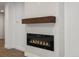 Modern fireplace with wooden mantel and black surround at 2500 S York St # 204, Denver, CO 80210