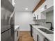 Updated kitchen featuring stainless steel appliances, white cabinets and stylish backsplash at 2500 S York St # 204, Denver, CO 80210