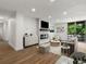 Staged living room with sleek fireplace, balcony access, and modern decor at 2500 S York St # 204, Denver, CO 80210