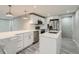 Modern kitchen with white shaker cabinets, quartz countertops, and stainless steel appliances at 4735 W Bayaud Ave, Denver, CO 80219