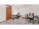 Finished basement area with office or craft space featuring wood door and gray carpeting at 19165 Golden Arrow Cir, Monument, CO 80132