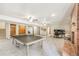 Spacious finished basement featuring a brick fireplace and a large ping pong table at 19165 Golden Arrow Cir, Monument, CO 80132