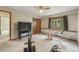 Carpeted basement featuring a large television, storage cabinets, and gym equipment at 19165 Golden Arrow Cir, Monument, CO 80132