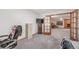 Finished basement area with carpeting, TV, and view to living room with fireplace at 19165 Golden Arrow Cir, Monument, CO 80132