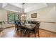 Bright dining room with hardwood floors, modern lighting, and a large window overlooking the trees at 19165 Golden Arrow Cir, Monument, CO 80132