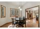 Bright dining room with hardwood floors, a view of nature, and access to the living area at 19165 Golden Arrow Cir, Monument, CO 80132