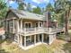 Multi-level deck features white railings, outdoor seating, and access to green yard at 19165 Golden Arrow Cir, Monument, CO 80132