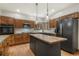 Well-lit kitchen with wood cabinets, a center island, stainless steel appliances, and hardwood flooring at 19165 Golden Arrow Cir, Monument, CO 80132