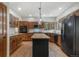 Bright kitchen featuring wood cabinets, a black island, stainless steel appliances, and hardwood floors at 19165 Golden Arrow Cir, Monument, CO 80132