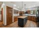 Charming kitchen with wood cabinets, a center island, and stainless steel appliances offering functionality and style at 19165 Golden Arrow Cir, Monument, CO 80132