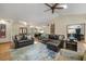Comfortable living room with vaulted ceiling, ceiling fan, two sofas, and view of the front door and dining area at 19165 Golden Arrow Cir, Monument, CO 80132