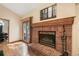 Elegant brick fireplace in the living room, with access to an outdoor deck and natural light at 19165 Golden Arrow Cir, Monument, CO 80132