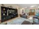 Cozy living room featuring hardwood floors, dark entertainment center, and a comfortable seating area at 19165 Golden Arrow Cir, Monument, CO 80132