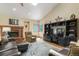 Spacious living room with vaulted ceilings, fireplace, built-in shelving, and cozy seating at 19165 Golden Arrow Cir, Monument, CO 80132