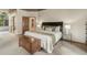 Comfortable main bedroom featuring a king-size bed, a chest, side tables, and a large window at 19165 Golden Arrow Cir, Monument, CO 80132