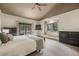 Relaxing main bedroom featuring a king-size bed, large windows, and a private balcony overlooking the trees at 19165 Golden Arrow Cir, Monument, CO 80132