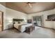 Relaxing main bedroom featuring a king-size bed, a chest, and a private balcony overlooking the trees at 19165 Golden Arrow Cir, Monument, CO 80132