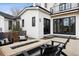 Backyard patio area with seating and modern fire pit, exterior with a white siding at 815 E Westglow Ln, Greenwood Village, CO 80121