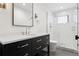 Modern bathroom with a sleek vanity, frameless mirror and glass-enclosed shower at 815 E Westglow Ln, Greenwood Village, CO 80121