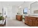 Elegant bathroom with dual sinks, wooden vanities, and large mirrors at 815 E Westglow Ln, Greenwood Village, CO 80121