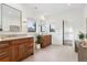 Elegant bathroom with dual sinks, wooden vanities, and large mirrors at 815 E Westglow Ln, Greenwood Village, CO 80121