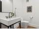 Modern powder room features a floating vanity, sleek fixtures, and minimalist decor at 815 E Westglow Ln, Greenwood Village, CO 80121