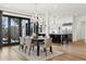 Elegant dining room with modern chandelier, light walls, and seamless flow to the gourmet kitchen at 815 E Westglow Ln, Greenwood Village, CO 80121