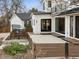 Stunning modern farmhouse exterior with white siding, black trim, and a spacious patio area at 815 E Westglow Ln, Greenwood Village, CO 80121