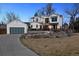 Striking modern farmhouse with large windows, black trim, and three-car garage on a professionally landscaped lot at 815 E Westglow Ln, Greenwood Village, CO 80121