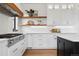 Bright and airy kitchen with stainless steel appliances, white cabinetry and light countertops at 815 E Westglow Ln, Greenwood Village, CO 80121