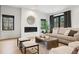 Inviting living room featuring a cozy fireplace, neutral-toned furniture, and an abundance of natural light at 815 E Westglow Ln, Greenwood Village, CO 80121