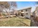 Expansive backyard featuring a deck, lawn, and fenced perimeter, ideal for outdoor activities and privacy at 468 Sylvestor Trl, Highlands Ranch, CO 80129