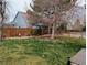A spacious backyard featuring a well-maintained lawn, privacy fence, and mature trees, perfect for outdoor entertaining at 468 Sylvestor Trl, Highlands Ranch, CO 80129