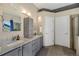 En-suite bathroom featuring double sink vanity, granite countertop, and walk-in shower at 468 Sylvestor Trl, Highlands Ranch, CO 80129
