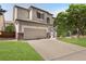 A charming two-story home featuring a two-car garage, well-maintained landscaping, and welcoming entryway at 468 Sylvestor Trl, Highlands Ranch, CO 80129