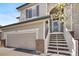Beautiful two-story home featuring a two-car garage and an inviting entrance with stairs leading to the front door at 468 Sylvestor Trl, Highlands Ranch, CO 80129