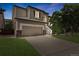 Attractive two-story home showcasing a two-car garage and landscaped front yard with staircase leading to the front door at 468 Sylvestor Trl, Highlands Ranch, CO 80129