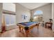 Spacious game room featuring a pool table, high ceilings, and large windows that provide abundant natural light at 468 Sylvestor Trl, Highlands Ranch, CO 80129
