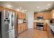 Bright kitchen with stainless steel appliances, ample counter space, and natural wood cabinetry at 468 Sylvestor Trl, Highlands Ranch, CO 80129