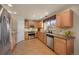 Well-equipped kitchen with stainless steel appliances, wood cabinets, and ample storage space at 468 Sylvestor Trl, Highlands Ranch, CO 80129