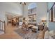 Inviting living room with high ceilings, large windows, and an open floor plan into the kitchen and dining area at 468 Sylvestor Trl, Highlands Ranch, CO 80129