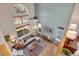 Spacious living room features high ceilings, a fireplace, hardwood floors, and large windows providing natural light at 468 Sylvestor Trl, Highlands Ranch, CO 80129