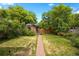 Lush backyard featuring a brick patio, vibrant flowers, and a detached brick garage at 346 N Corona St, Denver, CO 80218
